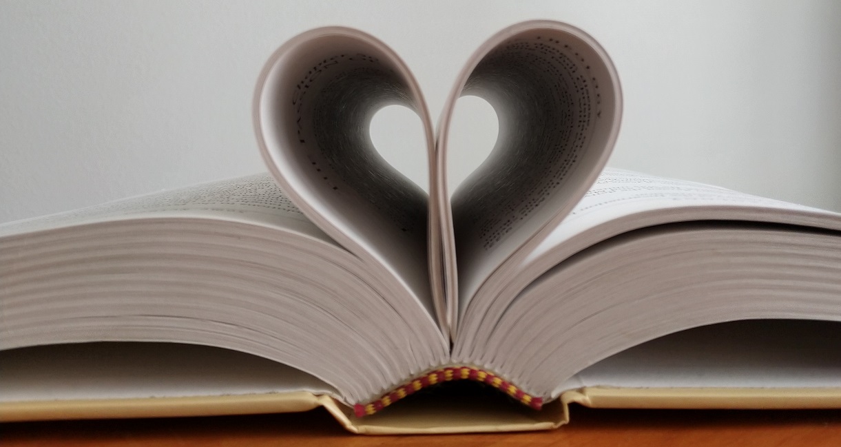 Picture of a Bible with some of its pages shaped into a heart